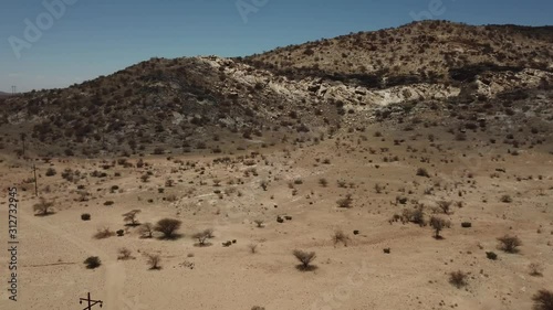 4K aerial drone video of gravel plains and Erongo Mountains near town Usakos, B1 highway to west coast of Namibia and dry waterless hot bushy savanna in Karibib District, central Namibia photo