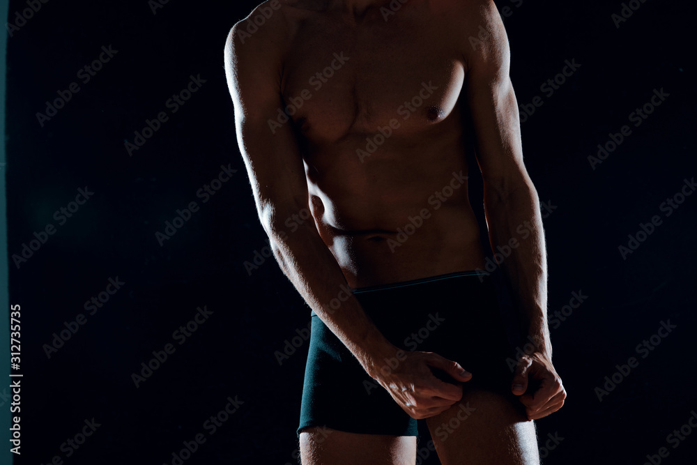 Fototapeta premium bodybuilder posing on black background