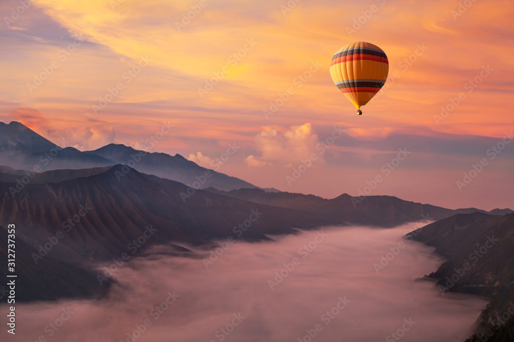 Fototapeta travel on hot air balloon, beautiful inspirational landscape with sunrise colorful sky