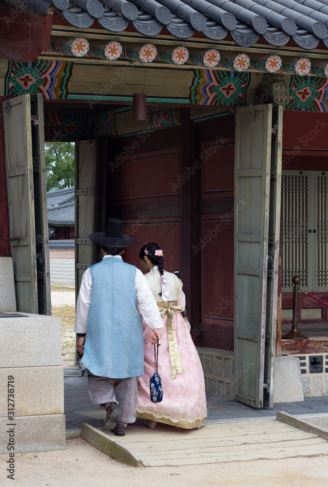 South Koean couple in traditional outfit walking in castle South Koean couple in traditional outfit walking in castle