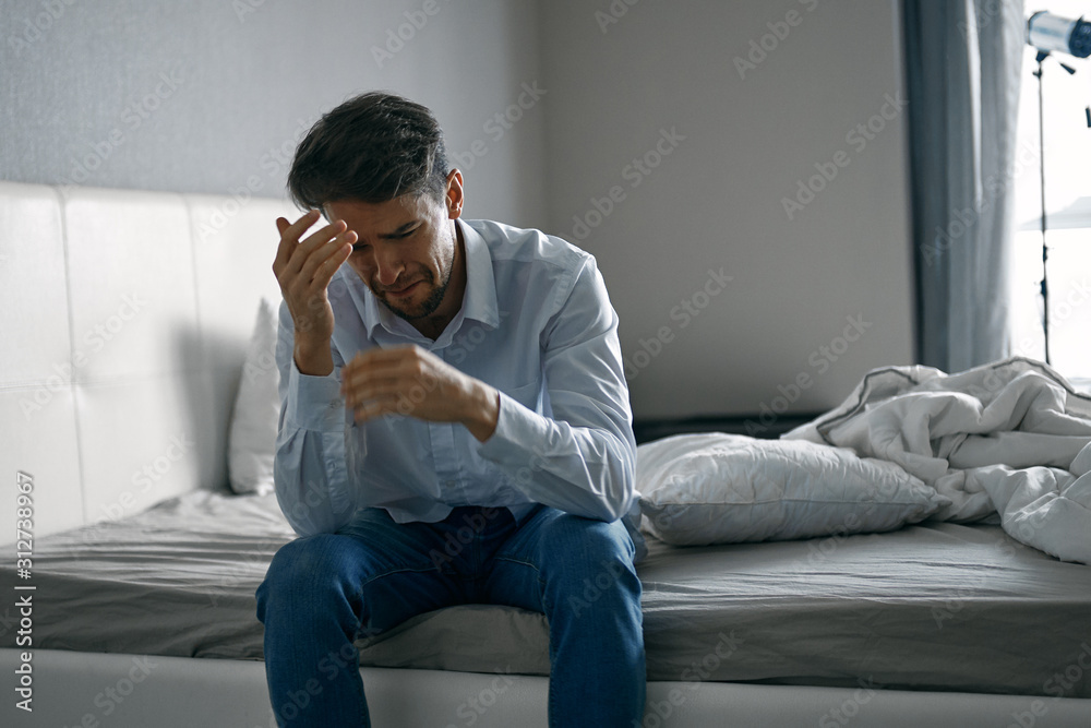 man sitting on sofa and talking on cell phone man sitting on sofa and talking on cell phone