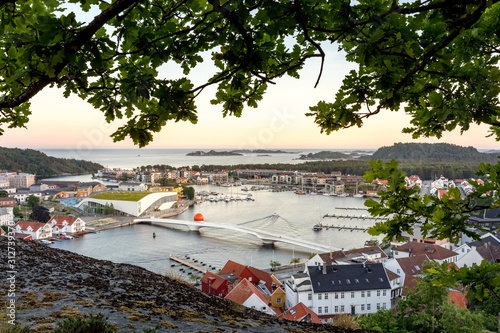 Mandal, Norway - june 2018: Mandal, a small town in the south of Norway. Seen from a height, with a cliff and an oak tree in the foreground. photo