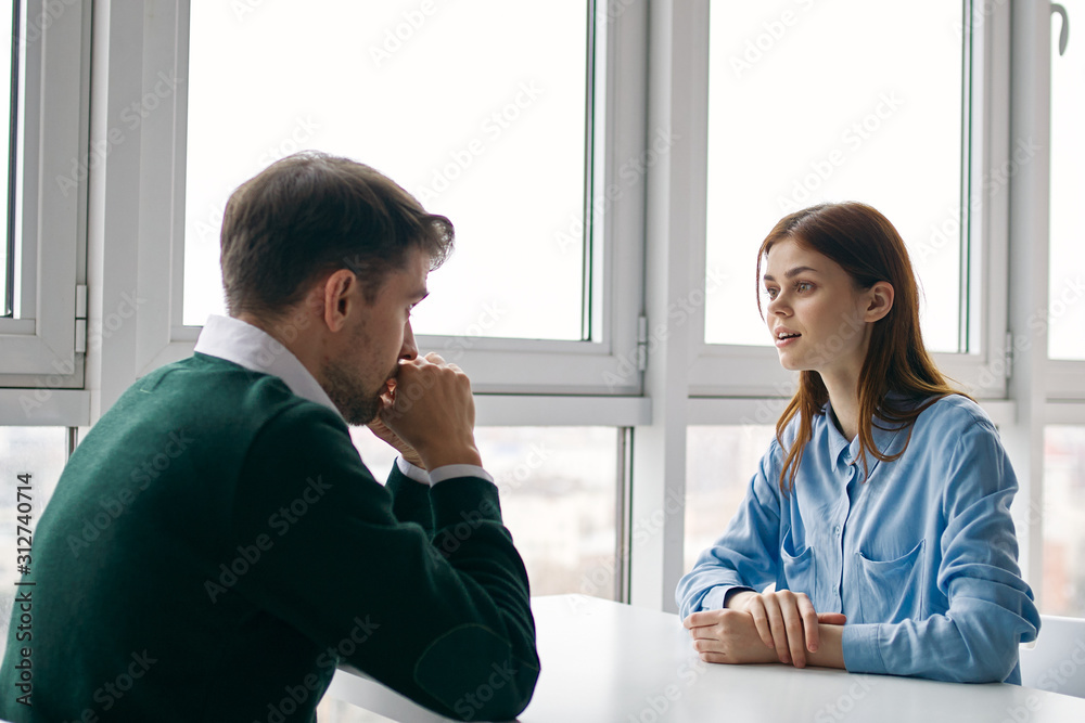 man and woman shaking hands in office