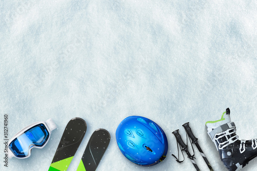 Ski equipment placed on snow. Free space above for text, logo promotion. Winter ski vacation concept. To view, flat lay
