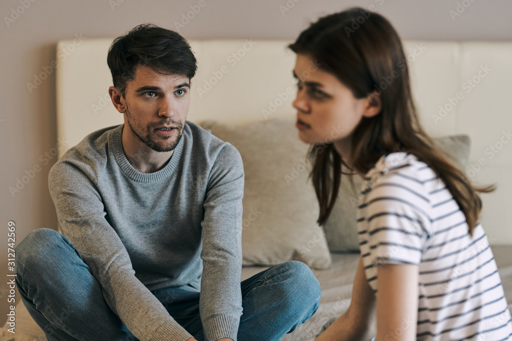 young couple sitting on sofa at home young couple sitting on sofa at home