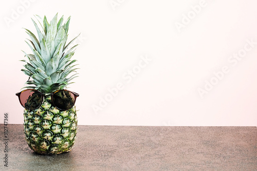 Cool exotic pineapple on light pink background