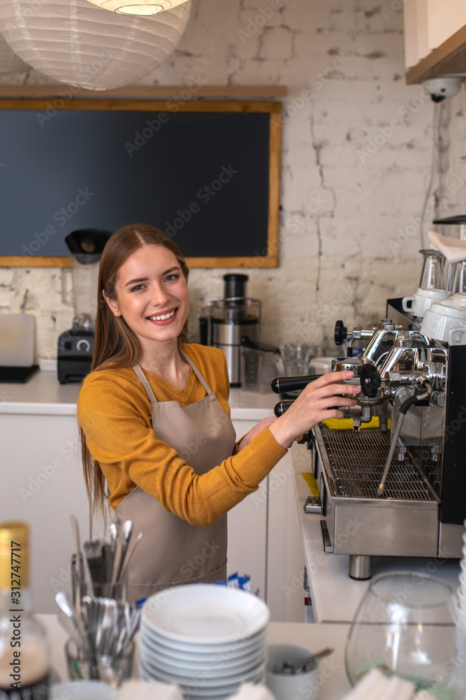 Smiling barista using professional equipment for her work Smiling barista using professional equipment for her work