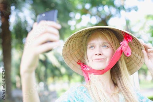 attractive blonde posing for selfie. Woman holding her phone taking at selfie . Traveling and exploring. 
