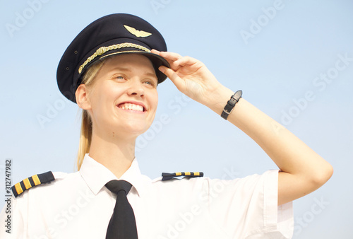 portrait of inspirational female woman at work smiling. Closeup of strong Female pilot in uniform. 
