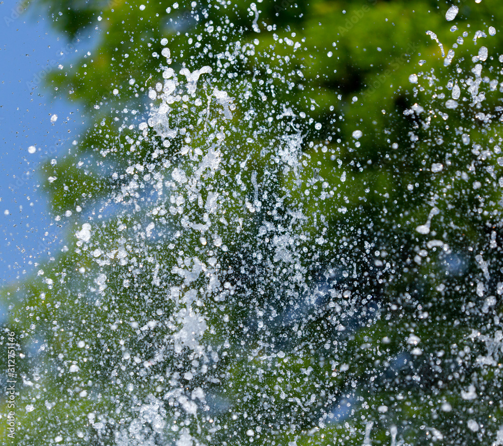 Fototapeta premium Water splashing from a fountain on summer nature