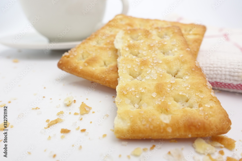 Cracker with coffee cup on white background Cracker with coffee cup on white background