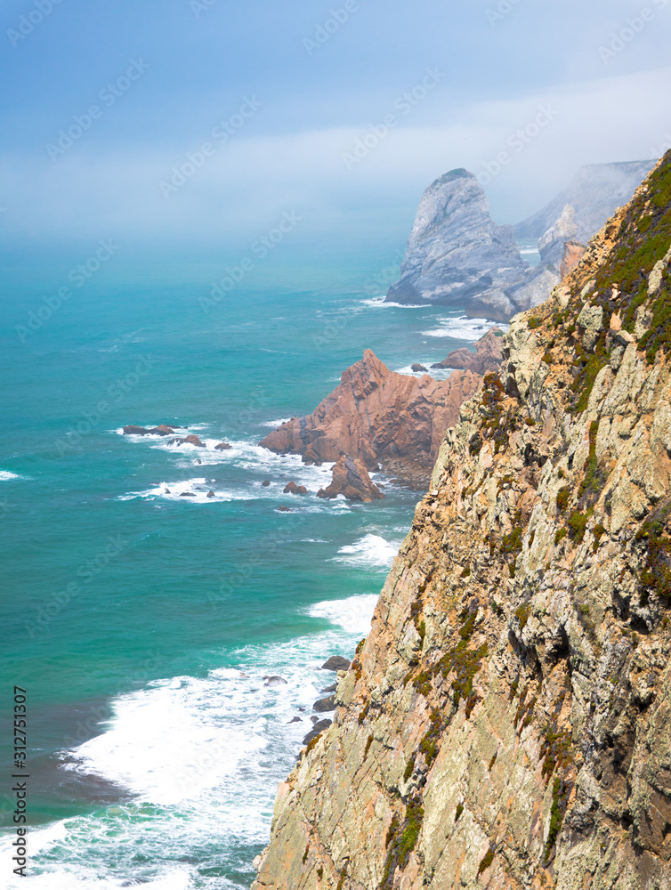 Portugal, Cabo da Roca, The Western Cape Roca of Europe, white clouds over the Atlantic ocean, ocean view from the Cape  Roca, cliff above the Atlantic ocean, azure water in the Atlantica