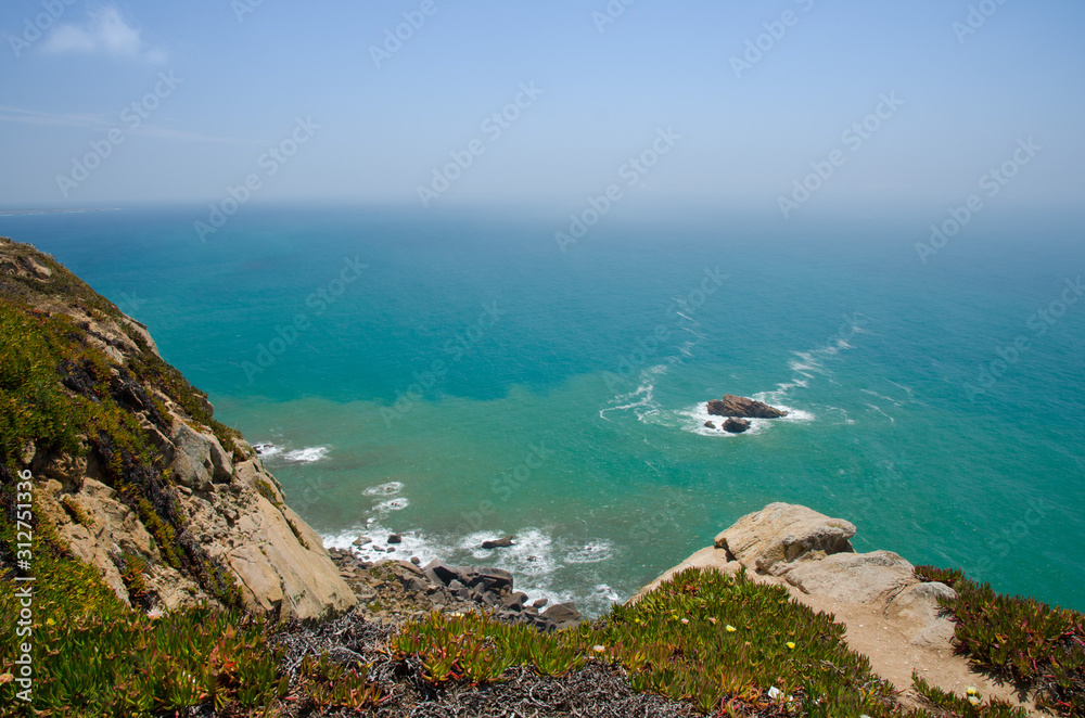 Portugal, Cabo da Roca, The Western Cape Roca of Europe,  white clouds over the Atlantic ocean, ocean view from the Cape  Roca, cliff above the Atlantic ocean, azure water in the Atlantica