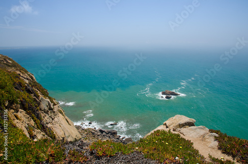 Portugal, Cabo da Roca, The Western Cape Roca of Europe, white clouds over the Atlantic ocean, ocean view from the Cape Roca, cliff above the Atlantic ocean, azure water in the Atlantica
