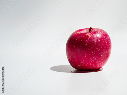 Organic red apple isolated on white background.