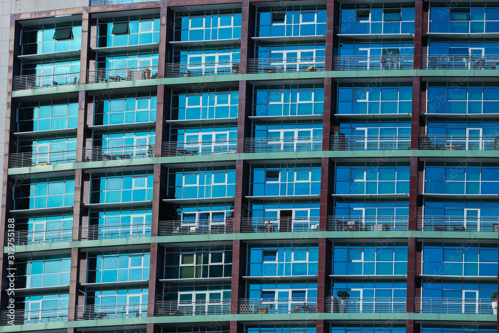 Multiple windows on a large apartment building Multiple windows on a large apartment building