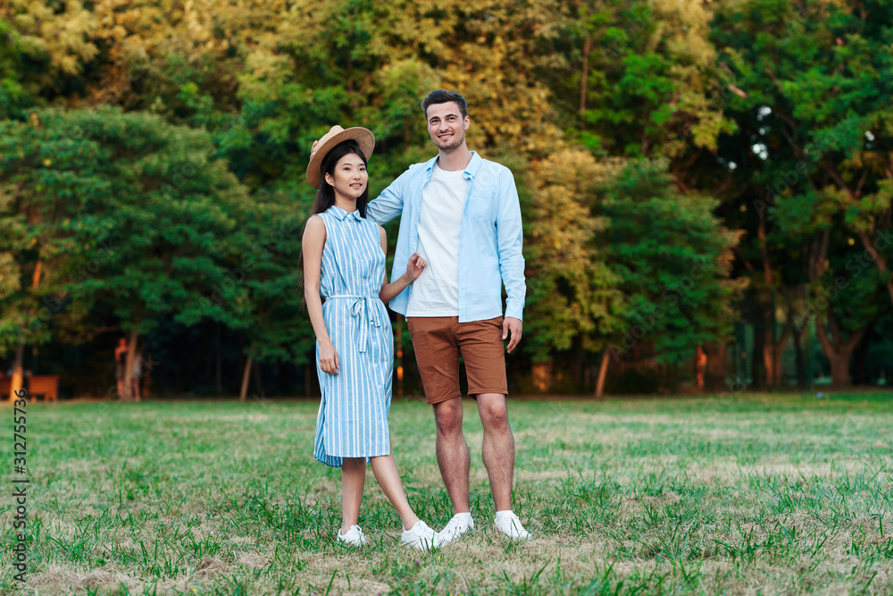 happy couple walking in the park