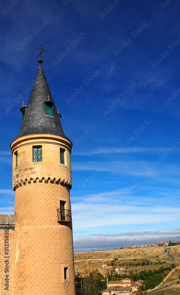 Tower of the famous Alcazar in Segovia, Spain, with the wide open plain in the background