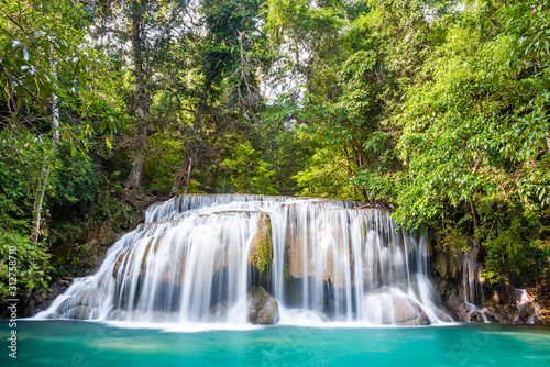 Waterfall and blue emerald water color in Erawan national park. Erawan Waterfall   Beautiful nature rock waterfall steps in tropical rainforest at Kanchanaburi province  Thailand
