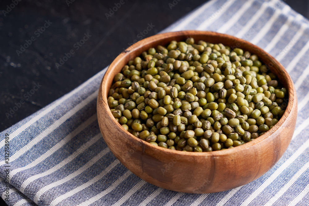 cereal mung beans mung in wooden bowl on black background cereal mung beans mung in wooden bowl on black background