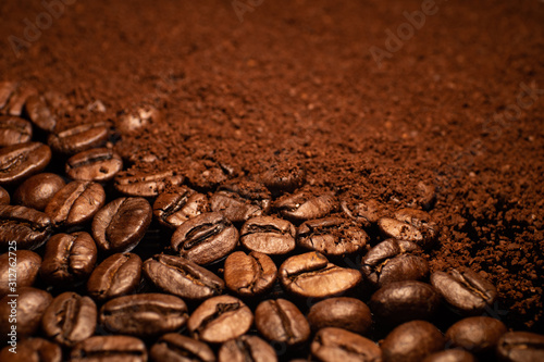 Roasted espresso coffee beans and powder closeup