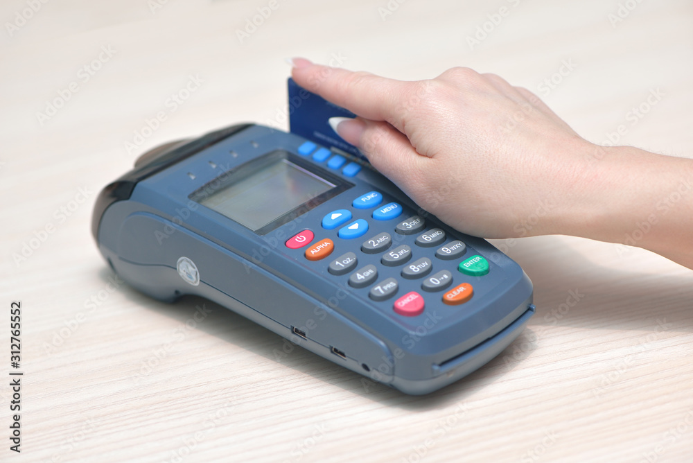 Girl pays purchase through the terminal pos Girl pays purchase through the terminal pos
