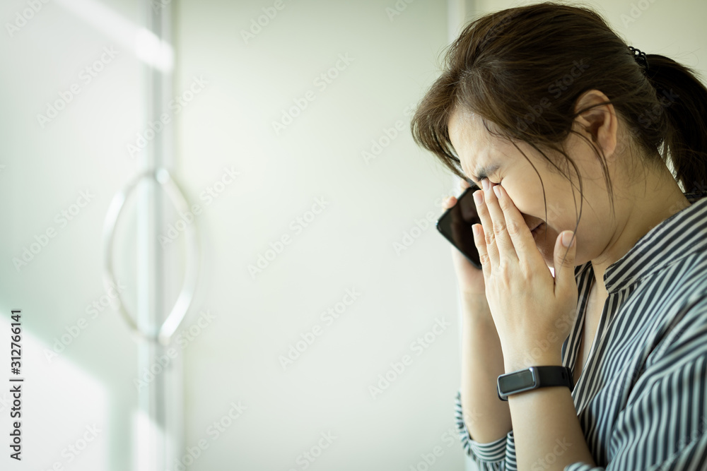 Sad asian woman using phone and grieving,crying alone in hospital,female people waiting for the doctor in front of the ICU room,feel stressed and worried about her husband about emergency accident Sad asian woman using phone and grieving,crying alone in hospital,female people waiting for the doctor in front of the ICU room,feel stressed and worried about her husband about emergency accident