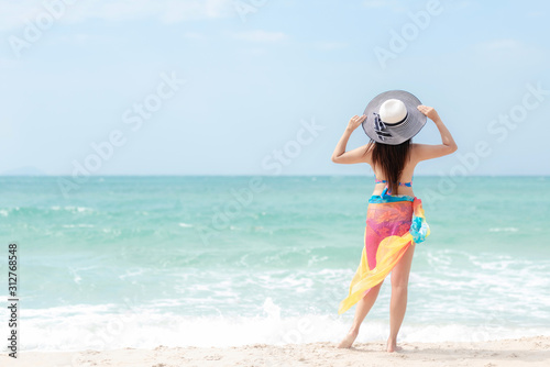 Summer Vacation. Traveler women relaxing and joy fun on the beach, so happy and luxury and destination in holiday summer. Tourism chill leisure on sand. Travel Trips and lifestyle Concept.