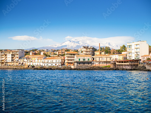 Great view of the Etna mount from the little harbor of Capomulini photo