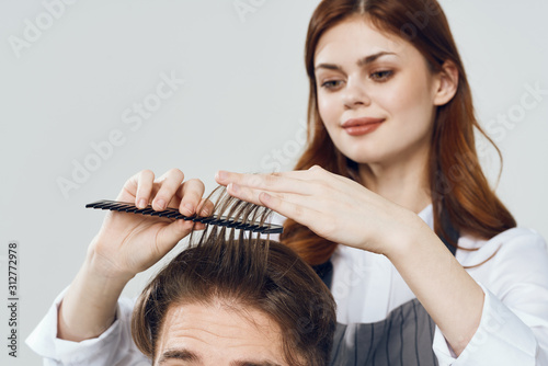hairdresser with scissors and comb