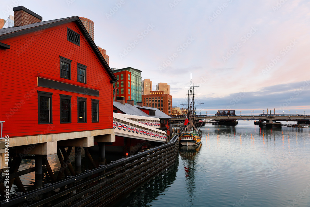 Naklejka premium Boston Harbor at sunrise viewing from Fan Pier Park. Boston Harbor is a natural harbor and estuary of Massachusetts Bay,
