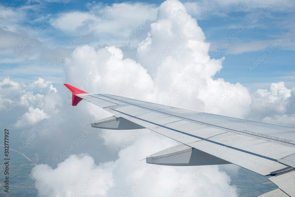 Look through the plane window and white cloud and blue sky Look through the plane window and white cloud and blue sky