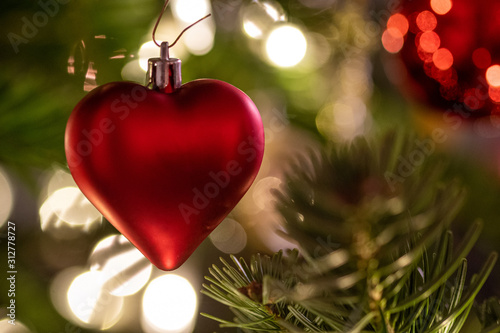 a red heart as christmas decoration on the christmas tree 2
