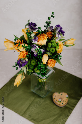 A bouquet of yellow roses with green balls