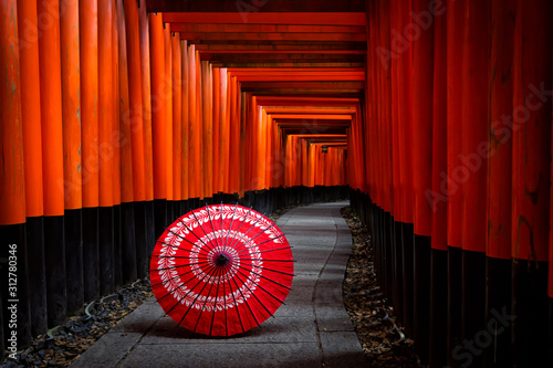 Canvas Print Kyoto,Japan - November 22,2019 : Japanese Umbrella and red torii gates walkway at fushimi inari shrine in Kyoto,Japan