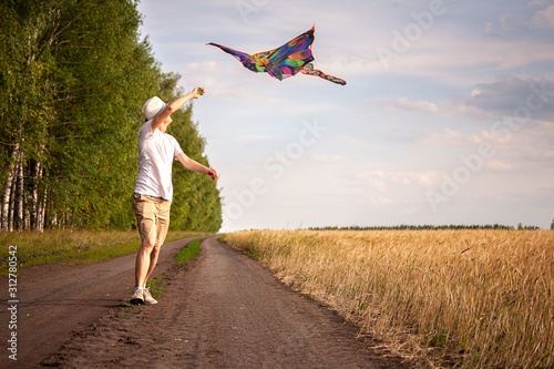 kite in hand against the blue sky in summer, flying kite launching, fun summer vacation, under the field, freedpm concept photo