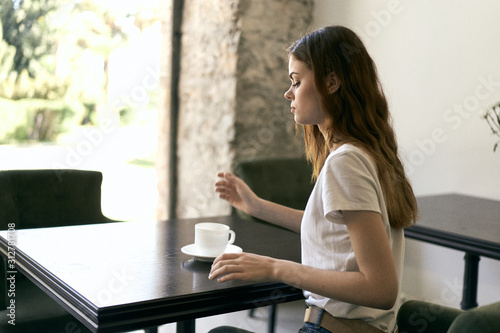 Free Download young woman using digital tablet in cafe - GFXLoad