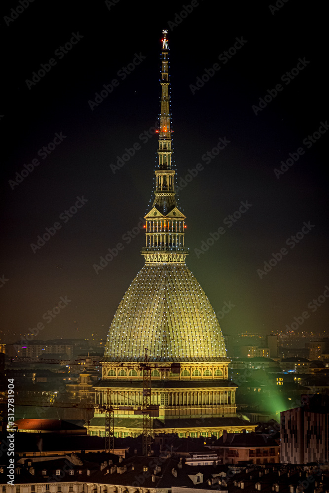 Scenic night cityscape of Turin with the Mole Antonelliana and Vittorio square lighted for the new year celebrations. Italy.