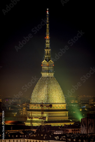 Scenic night cityscape of Turin with the Mole Antonelliana and Vittorio square lighted for the new year celebrations. Italy. photo