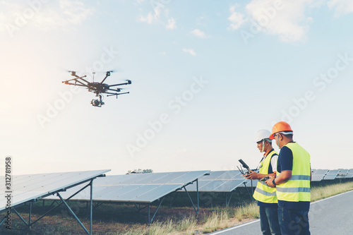 Inspector engineering concept; Engineer inspect solar panel  at solar power plant photo