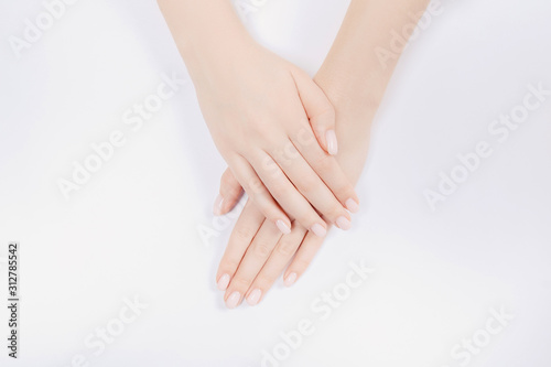 Fototapeta Naklejka Na Ścianę i Meble -  Stylish trendy nail young woman hands pink manicure on white background