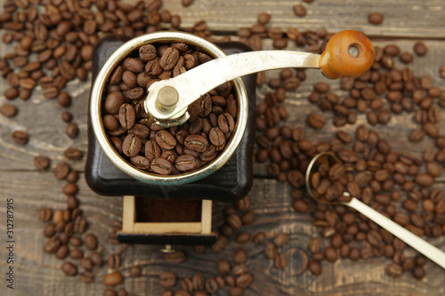 Coffee background with wooden coffee grinder and coffee beans and ground on wooden rustic background.. flat lay. Top view. Close-up.