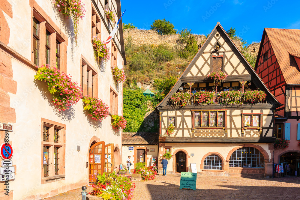Naklejka premium ALSACE WINE REGION, FRANCE - SEP 20, 2019: Colorful houses decorated with flowers in Kaysersberg village which is located on Alsatian Wine Route, France.