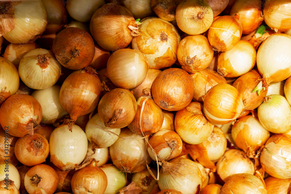 Golden onions at the supermarket counter. Diet and healthy eating. Close-up. Background. Space for text. View from above. Golden onions at the supermarket counter. Diet and healthy eating. Close-up. Background. Space for text. View from above.