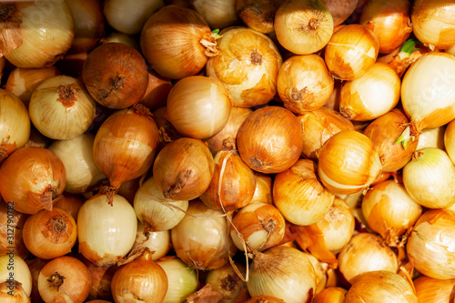 Golden onions at the supermarket counter. Diet and healthy eating. Close-up. Background. Space for text. View from above.