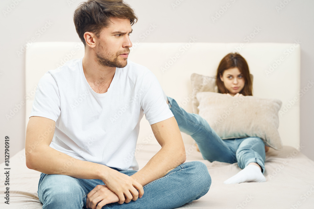 young couple sitting on sofa watching tv young couple sitting on sofa watching tv