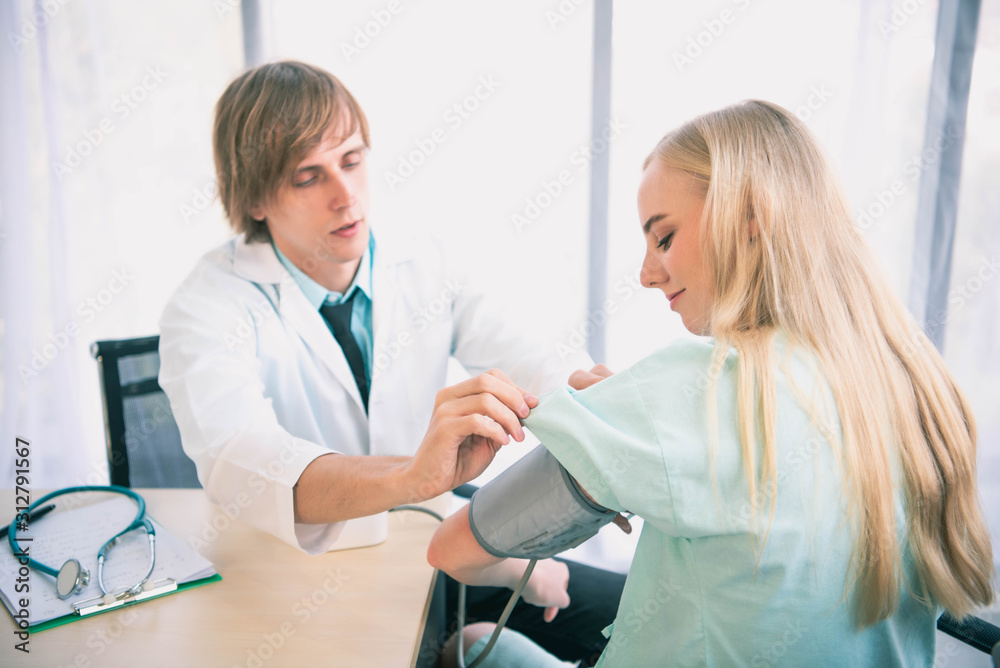 Fototapeta premium Young doctor speaking to patient or colleague