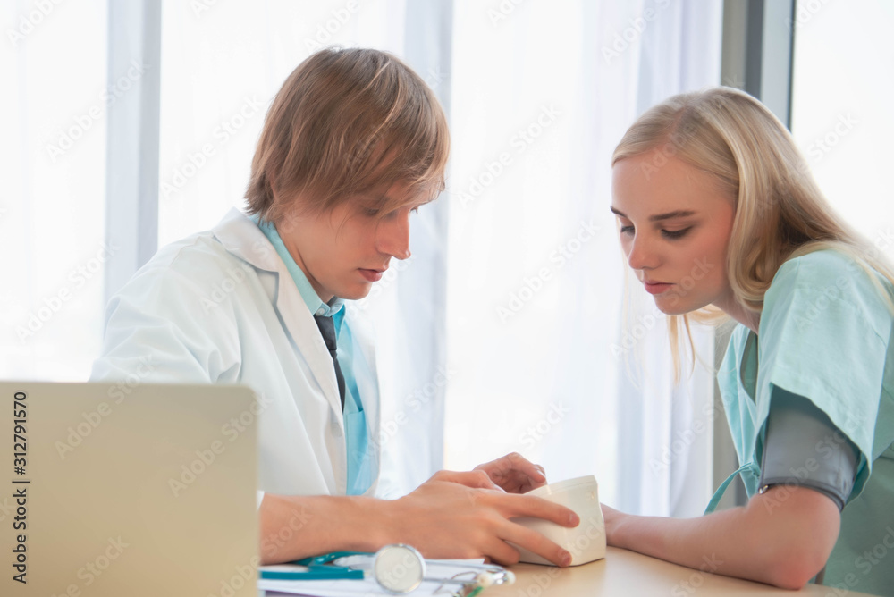 Young doctor speaking to patient or colleague Young doctor speaking to patient or colleague