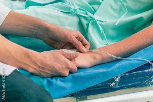 Young woman in wheelchair with doctor in hospital