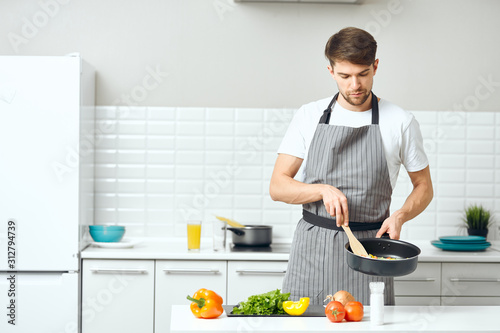 young man cooking in kitchen